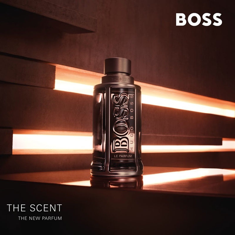 BOSS perfume bottle on a dark background with warm lighting