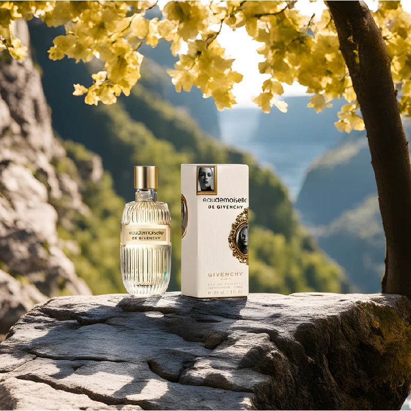 Givenchy perfume bottle and packaging on a rocky surface with a scenic background