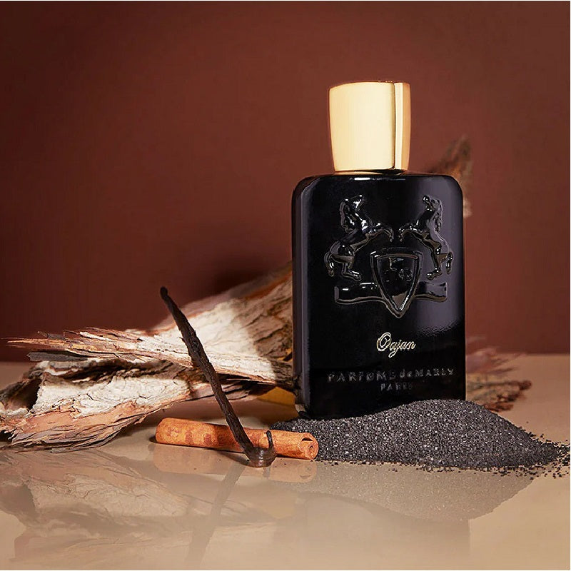 Lifestyle Image: Oajan 125 ml Eau de Parfum by Parfums de Marly – styled in a warm, luxurious setting evoking comfort, power, and golden sensuality.