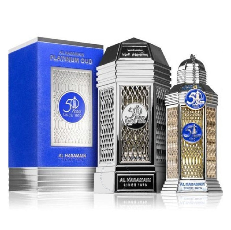A product image featuring a 100ml Eau de Parfum bottle of Platinum Oud by Al Haramain, with a decorative blue box in the background. The bottle is adorned with a silver cap and a transparent body displaying the amber-colored perfume.