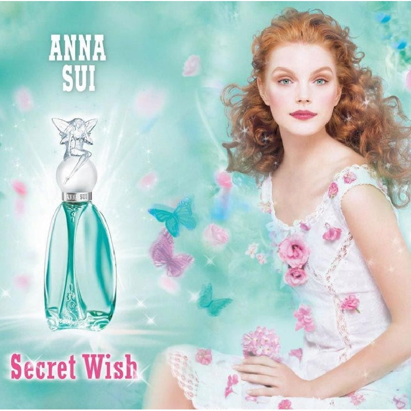 ANNA SUI Secret Wish perfume bottle with a model in a floral dress against a pastel background
