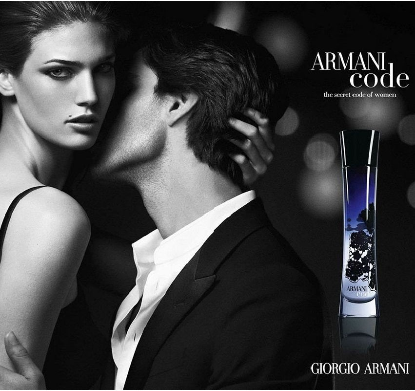 Advertisement for Giorgio Armani perfume featuring a woman and a man with a blurred background.
