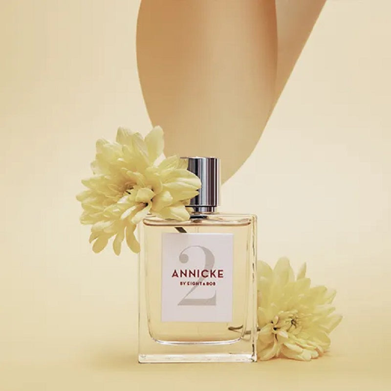 Perfume bottle labeled 'Annicke' with flowers on a beige background