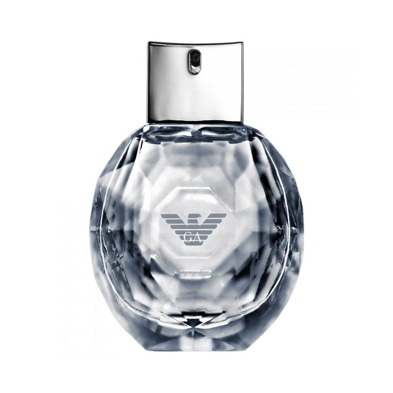 Clear perfume bottle with silver cap on a white background