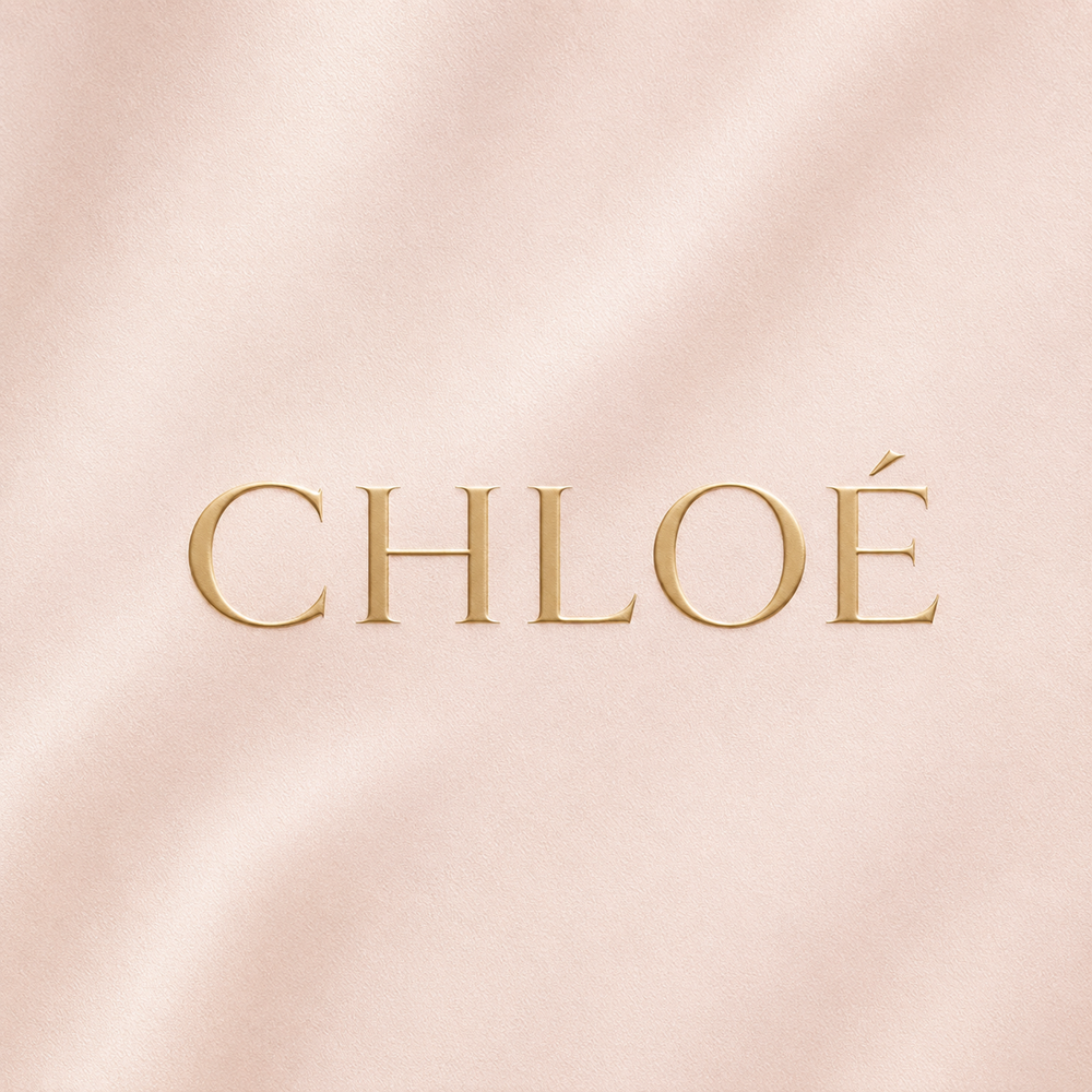 Champagne gold Chloé logo on a soft blush nude background