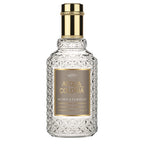 A clear glass bottle with a gold-colored label and a golden cap, labeled 4711 Acqua Colonia Myrrh + Kumquat.