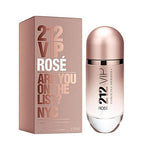A product image featuring a bottle of 212 VIP Rose Eau de Parfum by Carolina Herrera next to its packaging box. The bottle is clear with a rose gold cap, and the box is pink with gold text.