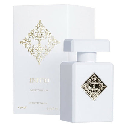 A white bottle of Initio Parfums Prives Musk Therapy eau de parfum with a gold cap and label, displayed next to its packaging box with a similar design.