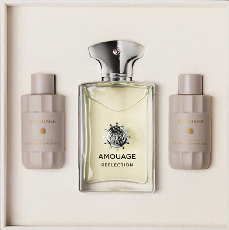Amouage Reflection perfume set with two smaller bottles on a light background