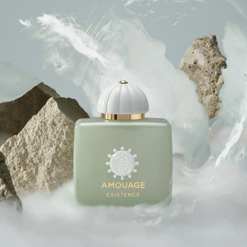 Amouage Existence perfume bottle with a natural rock and mist background