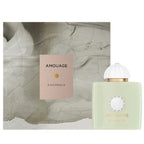 Amouage Existence perfume bottle and packaging on a textured beige background