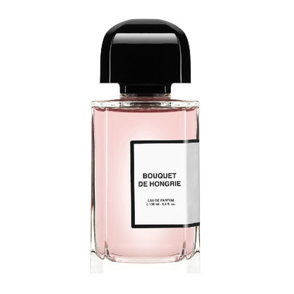 A 100ml bottle of Bouquet de Hongrie Eau de Parfum by BDK Parfums with a pink hue and a black cap.
