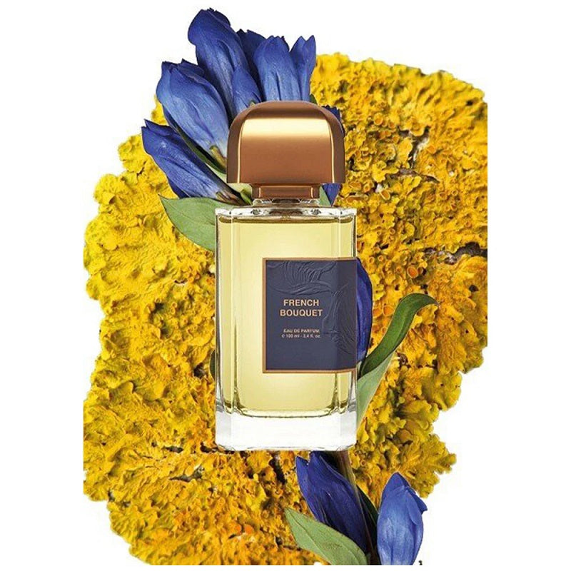 a 100ml BDK Perfume bottle labeled 'French Bouquet' surrounded by yellow flowers on a white background