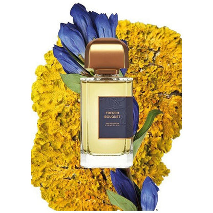 a 100ml BDK Perfume bottle labeled 'French Bouquet' surrounded by yellow flowers on a white background