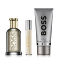 BOSS perfume set with a bottle, rollerball, and shower gel on a white background