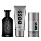 BOSS men's grooming products including a bottle, shower gel, and deodorant stick on a white background.