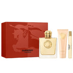 Burberry Goddess perfume set with red box, gold bottle, and cream tube on white background