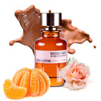 Perfume bottle labeled 'MAISON TAHITI' with chocolate, oranges, and a flower on a white background