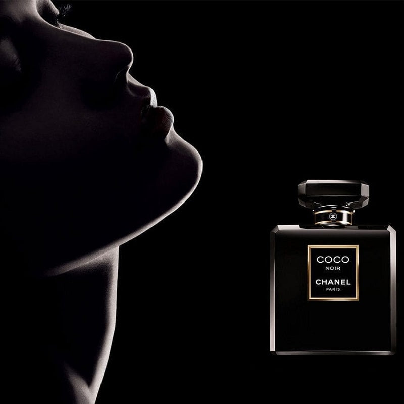 Chanel perfume bottle with a silhouette of a person against a black background
