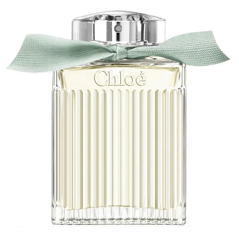 A bottle of Chloé Naturelle Eau de Parfum with a clear, light green liquid visible and a mint green ribbon around the top.