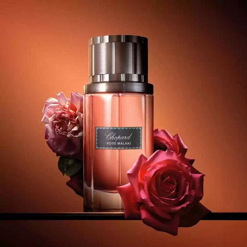 Chopard perfume bottle with roses on an orange background