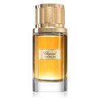 Chopard Oud Malaki perfume bottle with gold cap on a white background