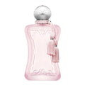 A pink, frosted glass bottle of Delina La Rosé (75ml) Eau De Parfum by Parfums De Marly with a silver cap and a pink tassel.