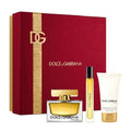 Dolce & Gabbana perfume set with red box, bottle, and cream on a white background