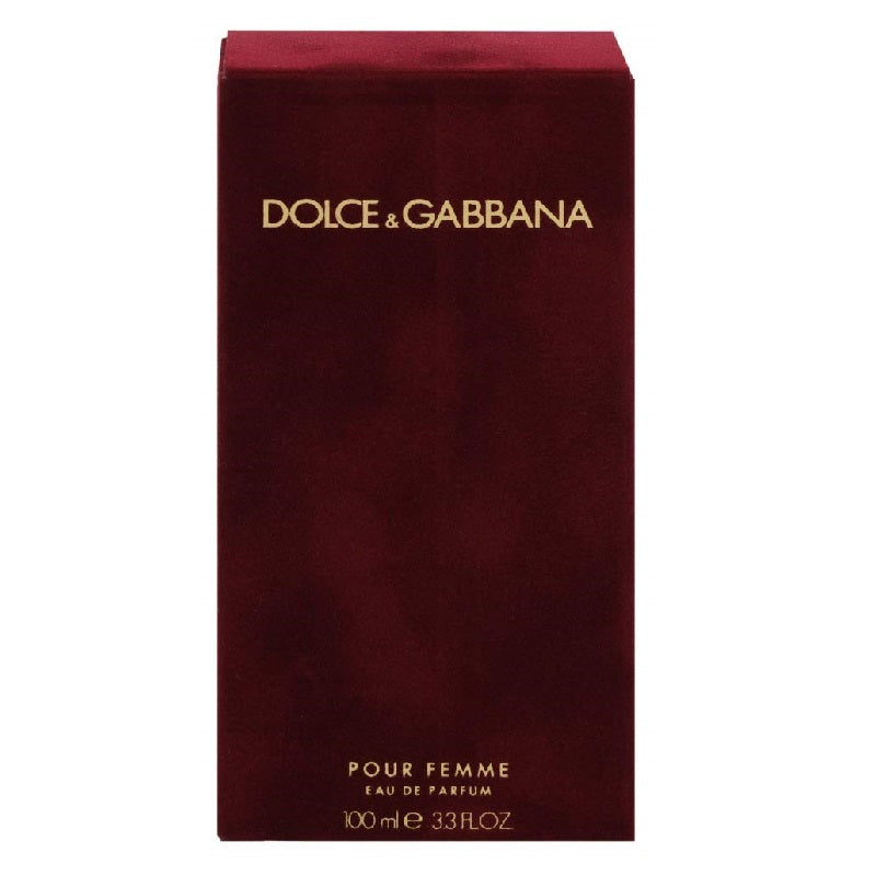 A red bottle of Dolce Pour Femme Eau de Parfum by Dolce & Gabbana with a gold cap and branding details.