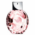 Pink perfume bottle with silver cap on a white background