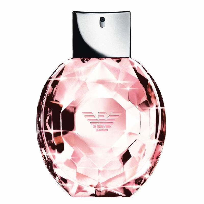 Pink perfume bottle with silver cap on a white background
