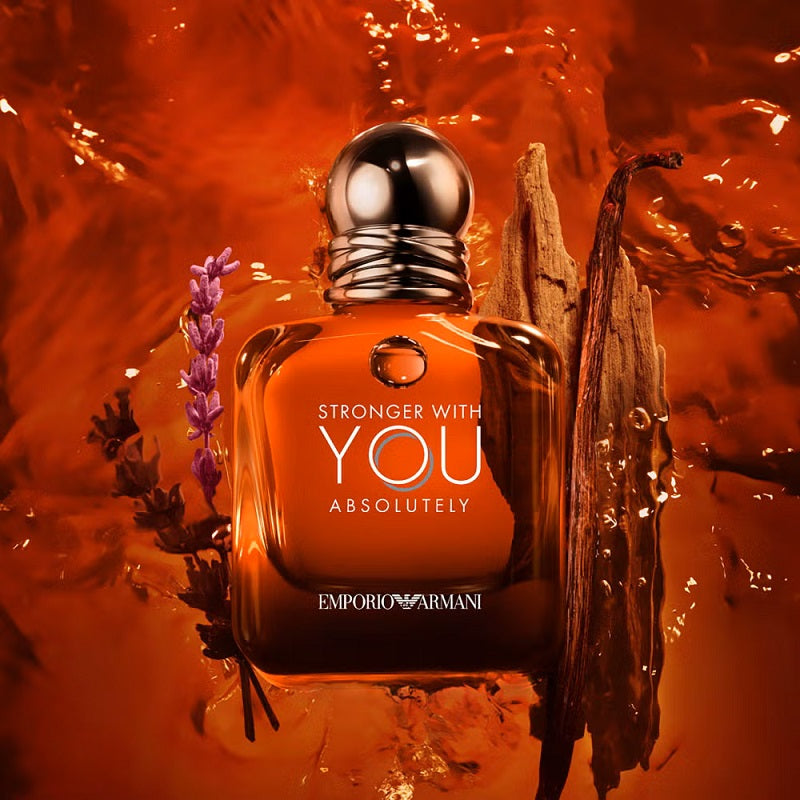 Perfume bottle with floral elements on an orange background, featuring the text 'Stronger with You Absolutely' and 'Emporio Armani'.