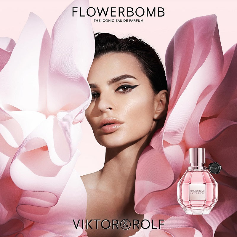 Advertisement for Viktor & Rolf Flowerbomb perfume with a woman and pink floral design.