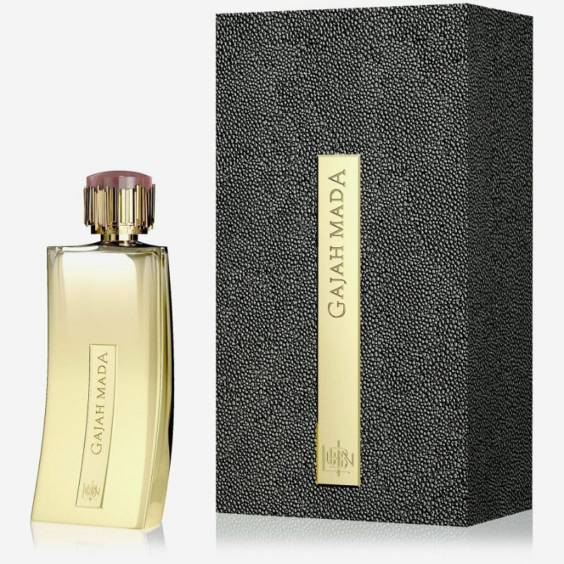 Gold perfume bottle and black textured packaging on a white background