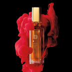 Perfume bottle labeled 'RED' with red smoke on a black background
