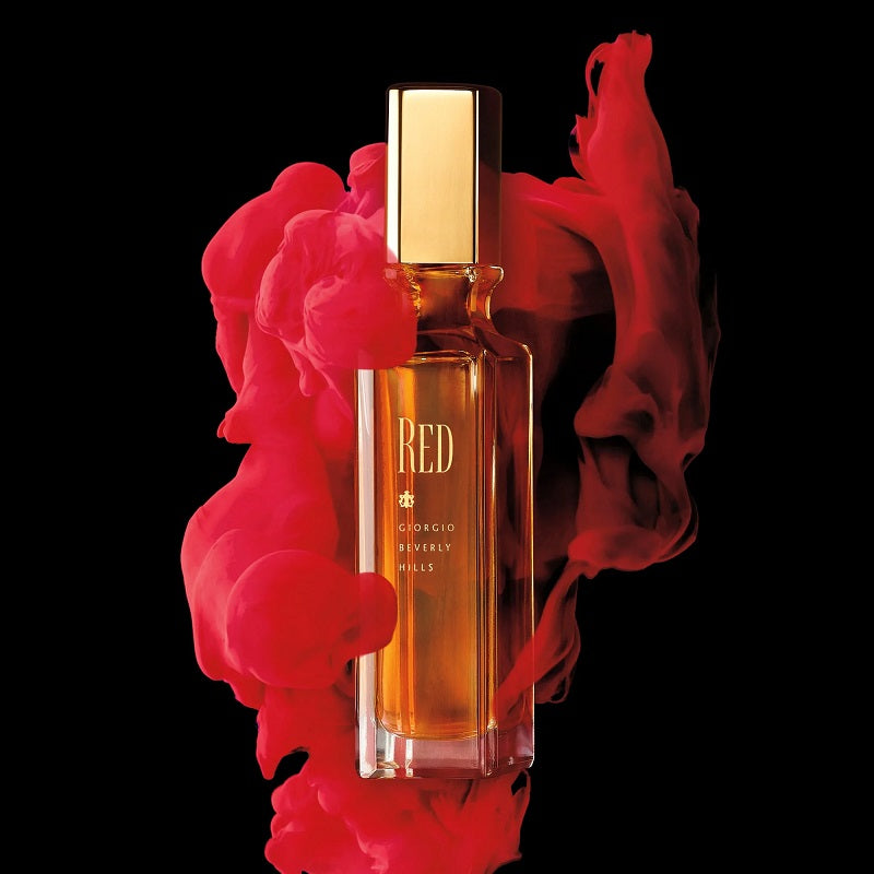 Perfume bottle labeled 'RED' with red smoke on a black background