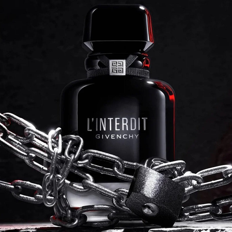 Givenchy L'Interdit perfume bottle with chains on a dark background