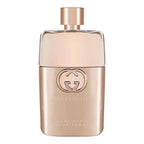 A spray bottle of Gucci Guilty Pour Femme eau de toilette with a gold-colored label and cap.