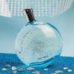 Blue perfume bottle with decorative background