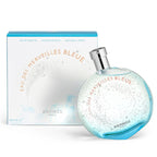 Blue perfume bottle with packaging on a white background