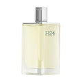 A clear glass bottle of Hermes H24 Eau de Toilette with a silver cap.