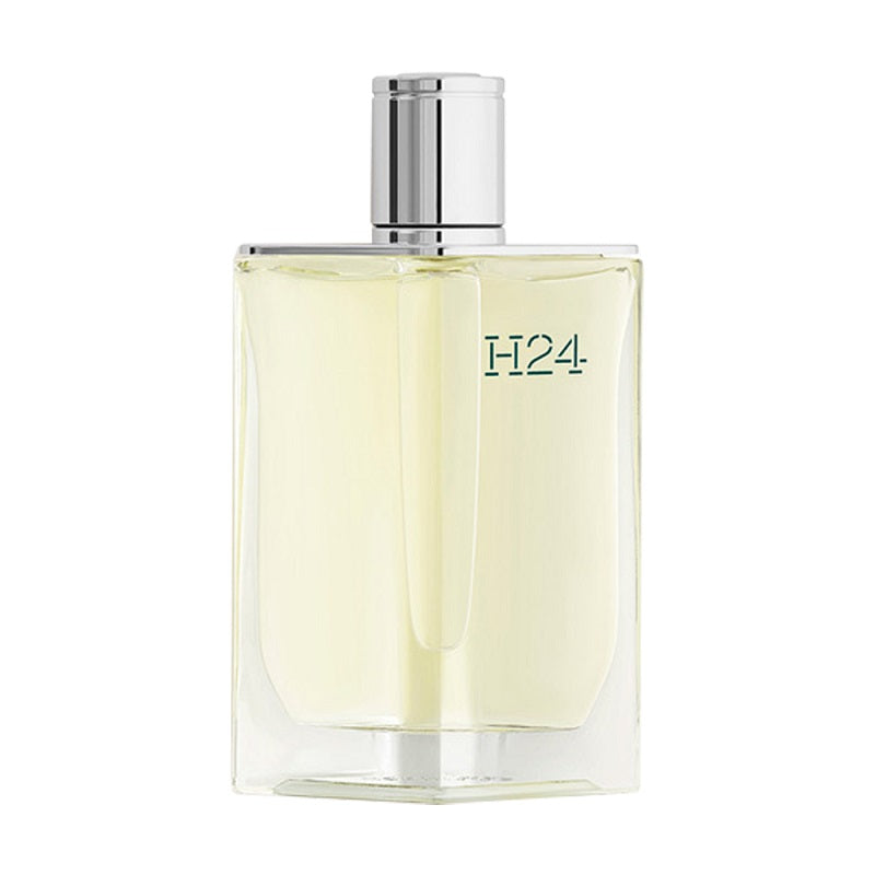 A clear glass bottle of Hermes H24 Eau de Toilette with a silver cap.