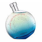 A bottle of Hermes L'Ombre des Merveilles eau de parfum with a blue to clear gradient and speckled design.
