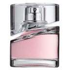 Pink perfume bottle with clear glass cap on a white background