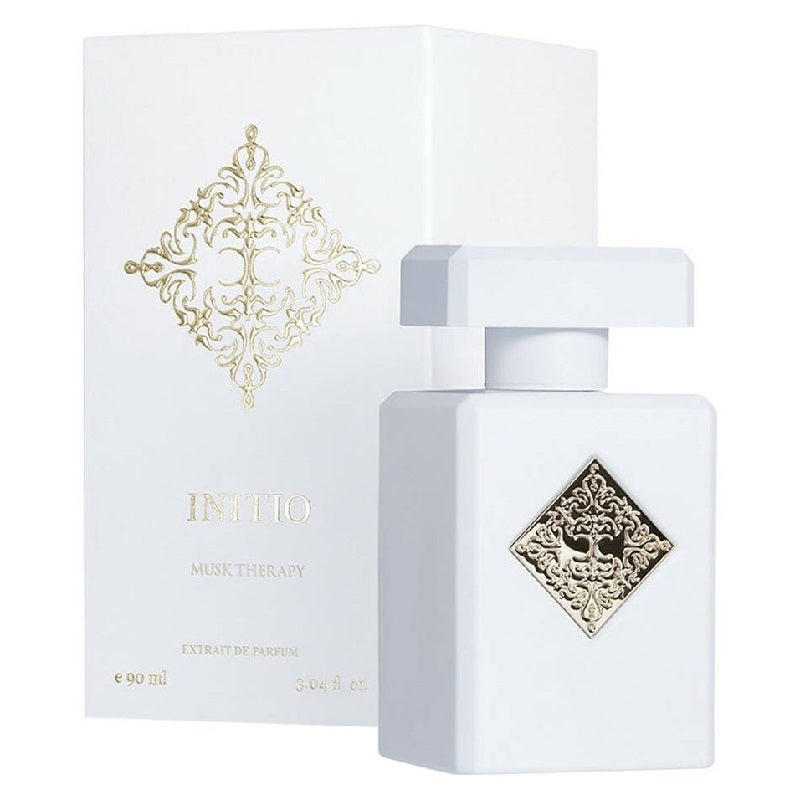 White perfume bottle and packaging with intricate gold designs on a white background