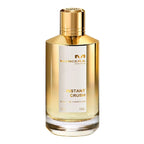 A bottle of Instant Crush Eau de Parfum by Mancera with a gold-colored cap and a clear, amber-colored liquid visible inside the bottle.