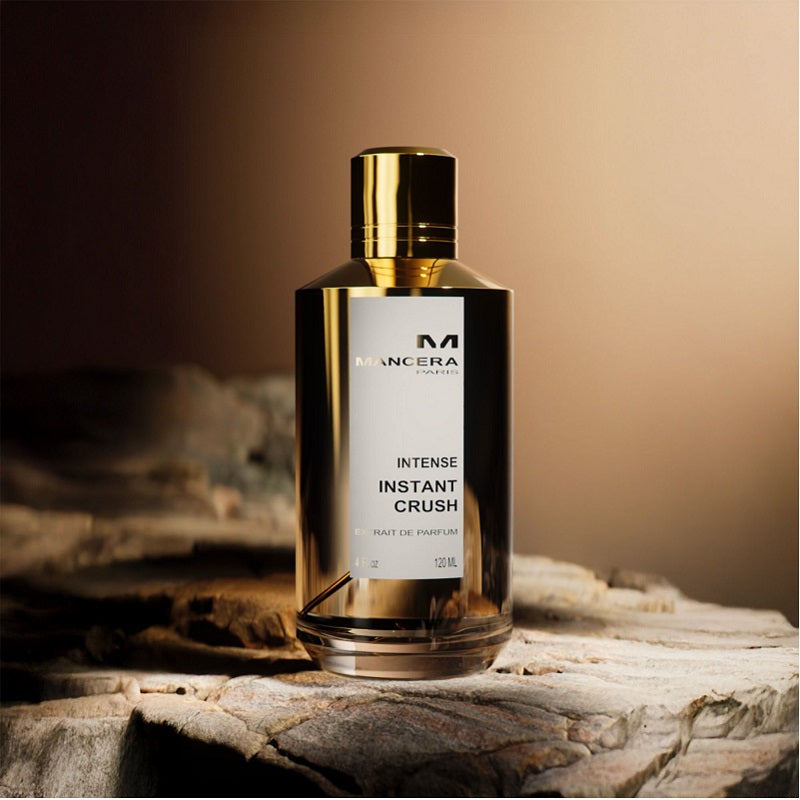 Mancera Intense Instant Crush perfume bottle on a stone surface with a warm background