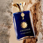 Amouage Interlude 53 perfume bottle against a textured stone wall background