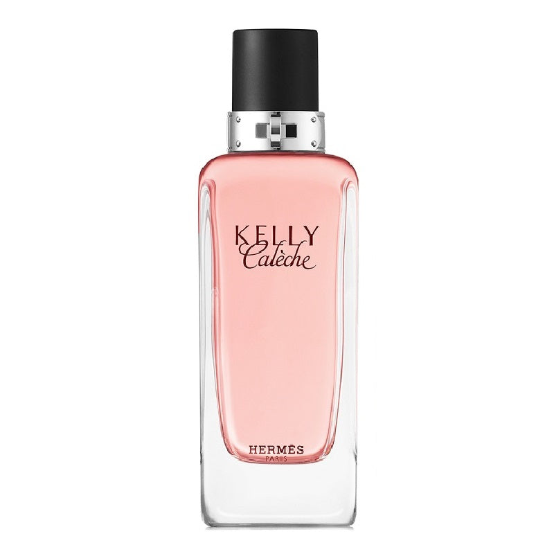 A glass bottle of Kelly Caleche Eau de Toilette by Hermès with a pink liquid visible and the brand and product name displayed on the label.