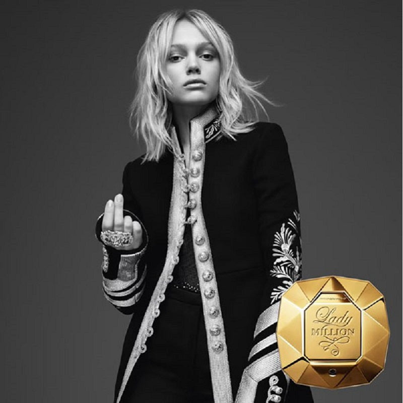Black and white portrait of a person in formal attire with a gold 'Perfume Lady Million' bottle.